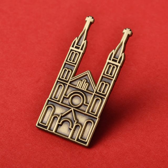 Blank metalen pin in de vorm van een kerk met twee torens, antiek goud